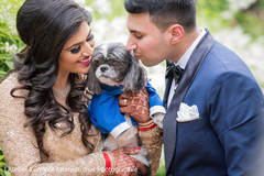 Adorable indian couple posing with dog indian wedding gallery,outdoor photography,indian bride and groom