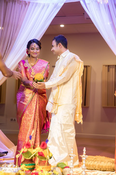 Indian bride and groom at their wedding ceremony bridal sari,indian bride fashion,indian wedding