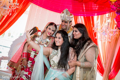 Dreamy indian bride and groom posing with family members photography Dreamy indian bride and groom posing with family members photography