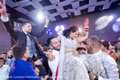 Indian bride and groom being lifted up capture Indian bride and groom being lifted up capture