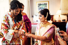 Sweet Indian bride putting bangles on. Sweet Indian bride putting bangles on.