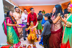 Indian wedding ritual of painting the bride with yellow turmeric paste Indian wedding ritual of painting the bride with yellow turmeric paste