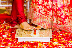 Indian bride and groom rolling betel nut with toes Indian bride and groom rolling betel nut with toes