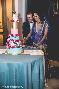 Lovely capture Indian bride and groom cutting cake together. Lovely capture Indian bride and groom cutting cake together.