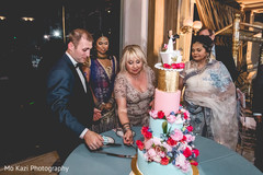 Indian wedding reception cutting the cake moment. Indian wedding reception cutting the cake moment.