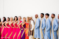 Lovely Indian couple posing outdoors with bridesmaids and groomsmen. Lovely Indian couple posing outdoors with bridesmaids and groomsmen.