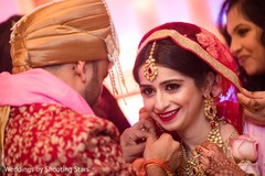 Indian groom putting flower garland to bride. Indian groom putting flower garland to bride.