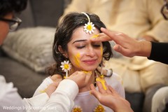Indian bride getting the turmeric paste on her haldi ceremony. Indian bride getting the turmeric paste on her haldi ceremony.