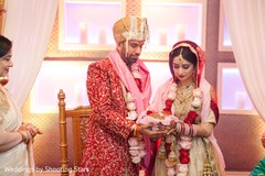 Indian bride and groom holding the coconut for wedding ritual. Indian bride and groom holding the coconut for wedding ritual.