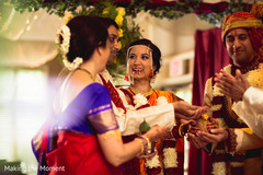Indian bride and groom holding the coconut at wedding ceremony. indian bride and groom,indian wedding fashion,indian wedding ceremony mandap,indian wedding flower decor