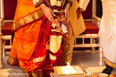 Indian couple making offerings to sacred fire. indian bride and groom,indian wedding ritual,indian wedding ceremony,indian wedding sacred fire