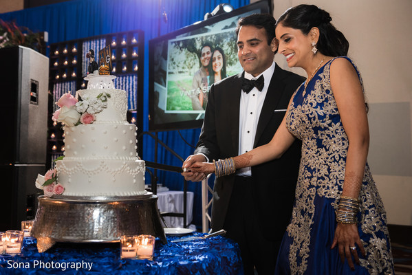 Lovely capture Indian bride and groom cutting cake together.