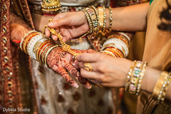 Indian bride being helped with jewelry Indian bride being helped with jewelry