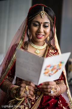 Marvelous Indian bride happy to read grooms postcard. Marvelous Indian bride happy to read grooms postcard.