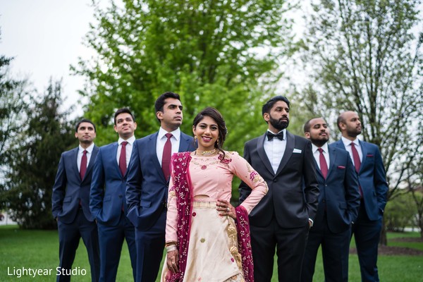 Indian couple posing with groomsmen