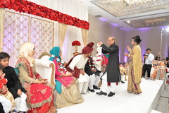Indian groom getting a garland from parent. Indian groom getting a garland from parent.