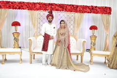 Indian bride and groom posing at fascinating Indian wedding mandap flowers decoration. Indian bride and groom posing at fascinating Indian wedding mandap flowers decoration.