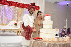 Indian newlyweds cutting the cake capture Indian newlyweds cutting the cake capture
