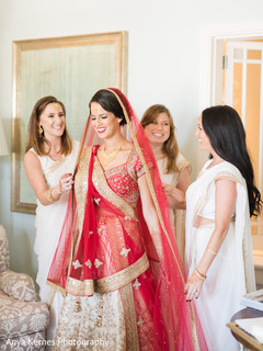 Indian bride getting her Ghoonghat put by bridesmaids. Indian bride getting her Ghoonghat put by bridesmaids.