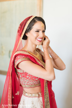 Lovely Indian bride getting her earrings on. Lovely Indian bride getting her earrings on.