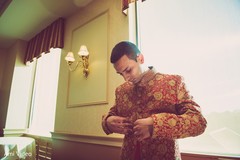 Indian groom putting his sherwani on. Indian groom putting his sherwani on.