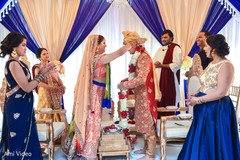 Indian bride and groom at their varmala ceremony garland exchange ritual. Indian bride and groom at their varmala ceremony garland exchange ritual.