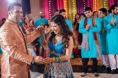 Indian couple dancing during sangeet Indian couple dancing during sangeet
