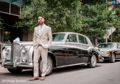 Charming indian groom posing with wedding car Charming indian groom posing with wedding car