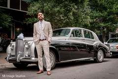 Elegant indian groom posing next to wedding car Elegant indian groom posing next to wedding car