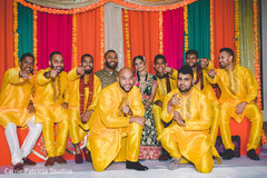 Indian bride and groom with groomsmen during sangeet celebration. Indian bride and groom with groomsmen during sangeet celebration.