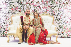 Stunning Indian Indian bride and groom at wedding reception mandap flower decorations. Stunning Indian Indian bride and groom at wedding reception mandap flower decorations.