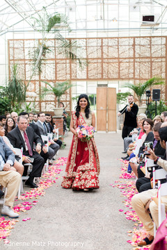 Lovely Indian bride about to enter to wedding ceremony bridal lengha,bridal fashion,bridal bouquet