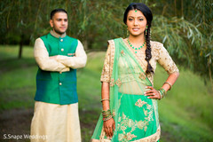 Marvelous Indian bride posing with her traditional pre-wedding sangeet outfit. Marvelous Indian bride posing with her traditional pre-wedding sangeet outfit.