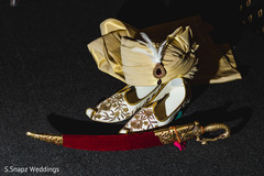 Majestic Indian groom's turban with jewelry, sword, and wedding shoes. . Majestic Indian groom's turban with jewelry, sword, and wedding shoes. .