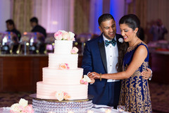 Lovely capture Indian bride and groom cutting cake together. indian bride and groom,indian wedding reception fashion,indian wedding cake