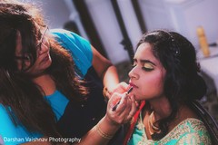 Indian bride getting makeup last touch ups for her wedding ceremony. Indian bride getting makeup last touch ups for her wedding ceremony.