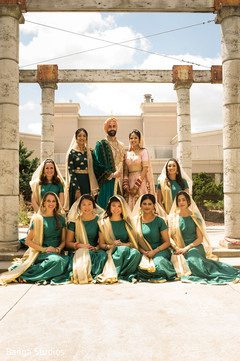 Charming indian couple posing with bridesmaids indian wedding gallery,outdoor photography,indian bride and groom,indian bridesmaids