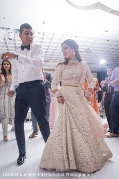 Indian newlyweds dancing with guests indian wedding reception,indian wedding reception photography,indian bride and groom