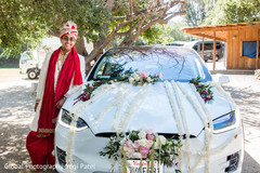 Indian groom posing next to wedding car Indian groom posing next to wedding car