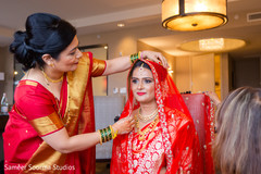 See the Final touch ups for this charming indian bride. indian wedding gallery,indian bride getting ready,bridal jewelry,indian bride fashion