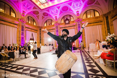 Dhol player leading wedding reception dance. Dhol player leading wedding reception dance.