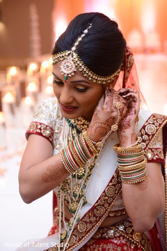Lovely indian bride putting her earrings on bridal jewelry,indian bride fashion,mehndi