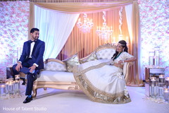Indian newlyweds in magnificent stage indian wedding,floral and decor,lighting