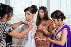 Indian bride being helped to get ready indian wedding gallery,indian bride getting ready,indian bride