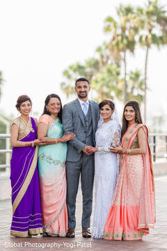 Cute indian couple with family portrait indian wedding gallery,outdoor photography,indian bride and groom
