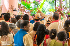 Indian wedding guests cheering during baraat Indian wedding guests cheering during baraat