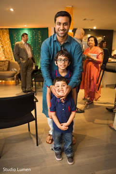 Charming indian groom posing with kids Charming indian groom posing with kids