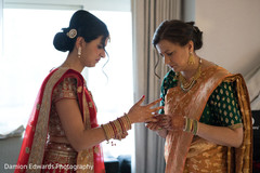 Indian bride putting her accessories on Indian bride putting her accessories on