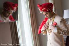 Indian groom putting his accessories on Indian groom putting his accessories on