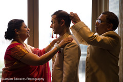 Indian groom getting ready with his parents Indian groom getting ready with his parents